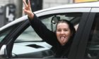 Carol Charles sticks her tongue out a she is driven away from Aberdeen Sheriff Court.