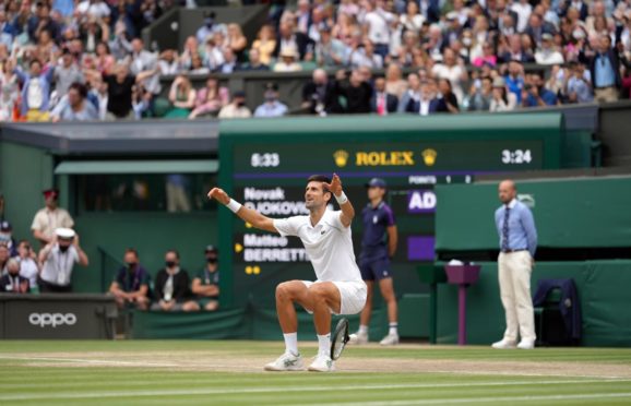 Novak Djokovic celebrates beating Matteo Berrettini to win Wimbledon 2021.