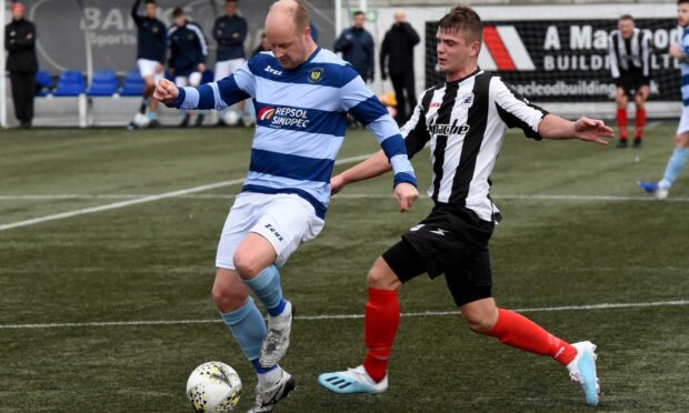 Banks o' Dee's Stuart Duff (left) and Dyce's Lewis Johnston battle or the ball.