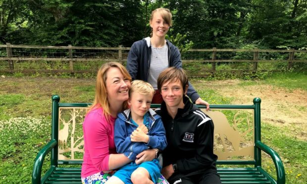 Esther Burns graduated from Aberdeen University after juggling with motherhood and a job as a nurse. Pictured: Esther Burns with her children Arwen, Zach and Paul.