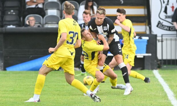 Elgin City's Brian Cameron gets in the thick of the action against Ross County.  Picture by Jason Hedges