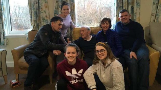 John Angus surrounded by his family inside the Home Farm care home on Skye.