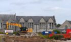The asbestos has delayed the demolition of the old Inverurie Academy.