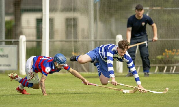 Kingussie's James Falconer, left, tangles with Craig Ritchie (Newtonmore).