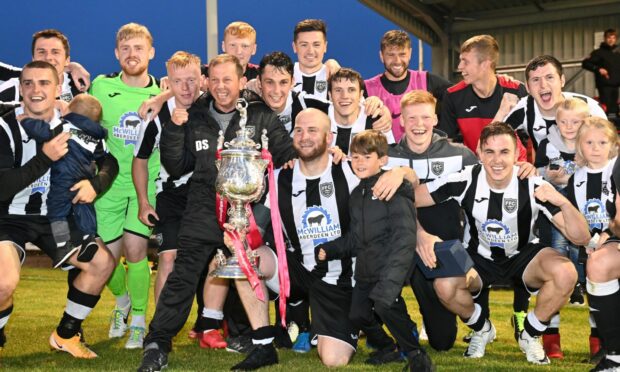 The Fraserburgh players celebrate with the Evening Express Aberdeenshire Cup trophy