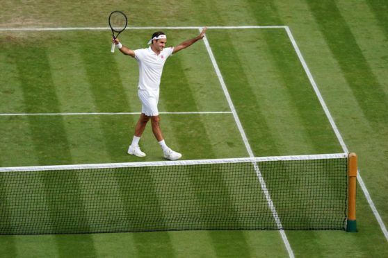 Roger Federer celebrates match point in the second round men's singles match against Richard Gasquet.