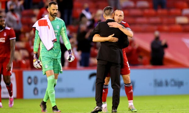 Aberdeen's Scott Brown celebrates with manager Stephen Glass at the end of the Europa Conference League tie.