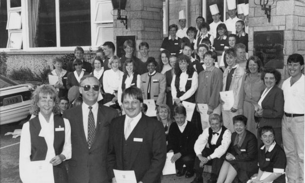 More than 60 staff members receiving their food hygiene awards from hotel general manager Mike Robins, front centre, in 1992.