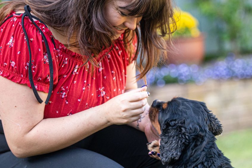 Toni Gordon feeding her dog