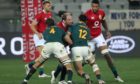 Lions captain Alun-Wyn Jones is double tackled as he tries to carry.