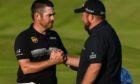Leader Lopuis Oosthuizen is congratulated by defending champion Shane Lowry.