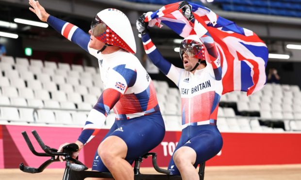 Great Britain Neil Fachie and pilot Matt Rotherham celebrate their victory in Tokyo.