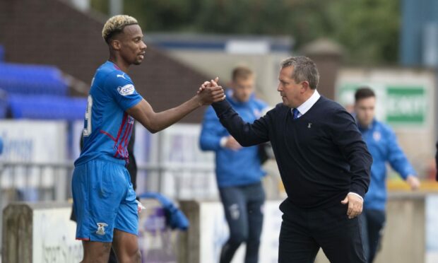 Manny Duku and head coach Billy Dodds shake hands after the striker came off late on against Raith Rovers at the weekend.