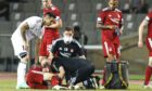 Andy Considine lies injured during the UEFA Conference League qualifier between Qarabag and Aberdeen at the Tofiq Bahramov Republican Stadium.