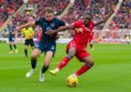 Aberdeen's Austin Samuels and Ross County's Connor Randall in action