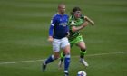 Harry Clarke, on loan for Oldham last year, tussles with Josh Davison of Forest Green Rovers.