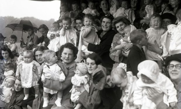 A beautiful baby contest in the rain during stay-at-home holiday week at Hazlehead Park in 1944.