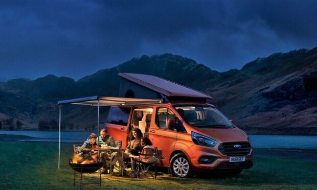 The Ford Nugget sleeps four with side and top awnings for extra sleeping and outdoor space.