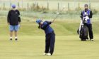 Kelsey MacDonald hits into the 18th green in the first round at Carnoustie.