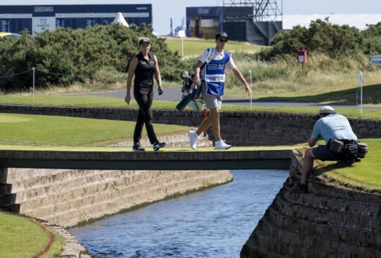 Lexi Thompson and her caddie Paul Drummond cross the Barry Burn at Carnoustie.