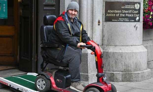 Mark Glen leaving court on his mobility scooter.