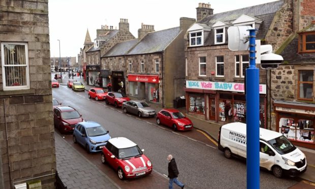 Fraserburgh town centre, with buildings and cars.