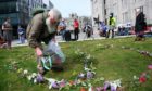 Hirishima day commemoration outside Marischal College. Pictured is Richard Caie who visited Hiroshima in 1982 whist in the royal navy laying flowers at the CND sign. Picture by Paul Glendell.