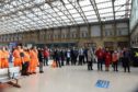 Workmen and staff observe a minute’s silence at Aberdeen railway station on the anniversary of the Stonehaven rail crash (Photo: Paul Glendell/DCT Media)