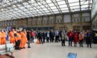 Workmen and staff observe a minute’s silence at Aberdeen railway station on the anniversary of the Stonehaven rail crash (Photo: Paul Glendell/DCT Media)