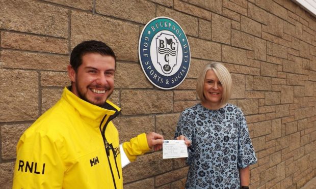 Gav Hyne (left), deputy mechanic of RNLI Buckie Lifeboat, accepts a donation of £250 from Amanda Fraser, administrator of Buckpool Golf Club.