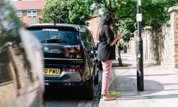 A driver ""fills up" at a Shell-owned ubitricity charge post in London.