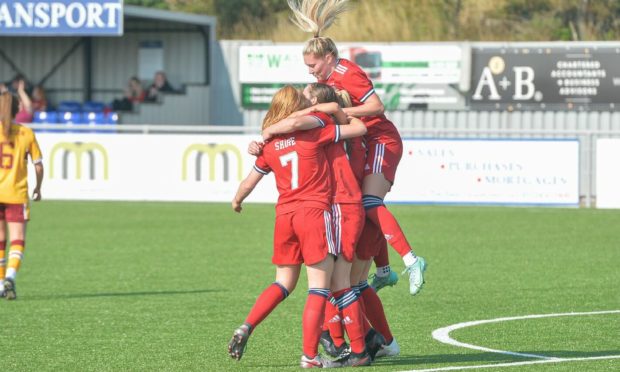 The Aberdeen players celebrate Bayley Hutchison's winner. 
Picture by Wullie Marr / DCT Media