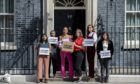 Campaigners hand in an open letter signed by over 80,000 people to Downing Street opposing the huge new Cambo oil field off Shetland. Stop Cambo / David Mirzoeff