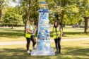 Clan’s Fiona Fernie and Diane McDonald in Westburn Park with a stunning lighthouse that was sponsored by Subsea 7 and created by Celie Byrne.