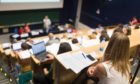 Scottish universities are continuing with a policy of not holding large lectures, despite relaxed Covid restrictions.