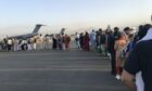 People queue up to board a military aircraft and leave Kabul (Photo: Xinhua/Shutterstock)