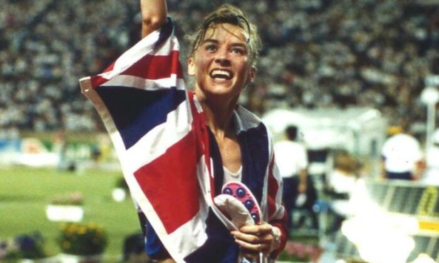 Liz McColgan waves to the crowd after winning gold in Tokyo.