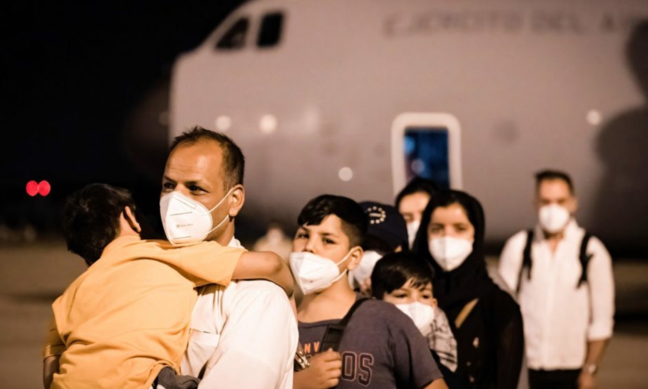 Afghan refugee families arrive at the Torrejón de Ardoz military base in Madrid in August 2021. Diego Radames/SOPA Images/Shutterstock