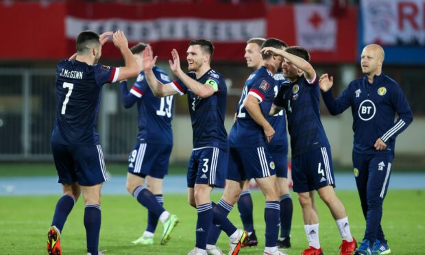 The Scotland players celebrate at full time after the victory in Austria.