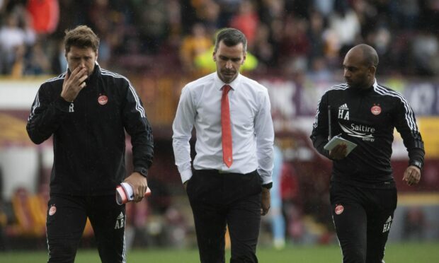 Aberdeen manager Stephen Glass (centre), No.2 Allan Russell and coach Henry Apaloo after the loss at Motherwell.