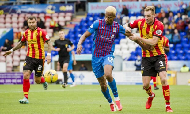 Caley Thistle striker Manny Duku holds off Kevin Holt in ICT's 3-1 win over Partick Thistle this season.