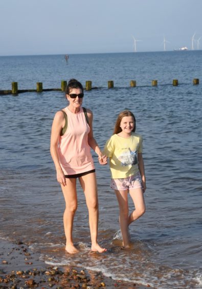 Pictured at Aberdeen beach are Debbie Corkey left and her daughter Sarah, 11. Picture by Chris Sumner.