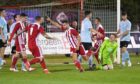 Formartine's Scott Lisle, arm raised, celebrates scoring for Formartine against Deveronvale in the Evening Express Aberdeenshire Cup