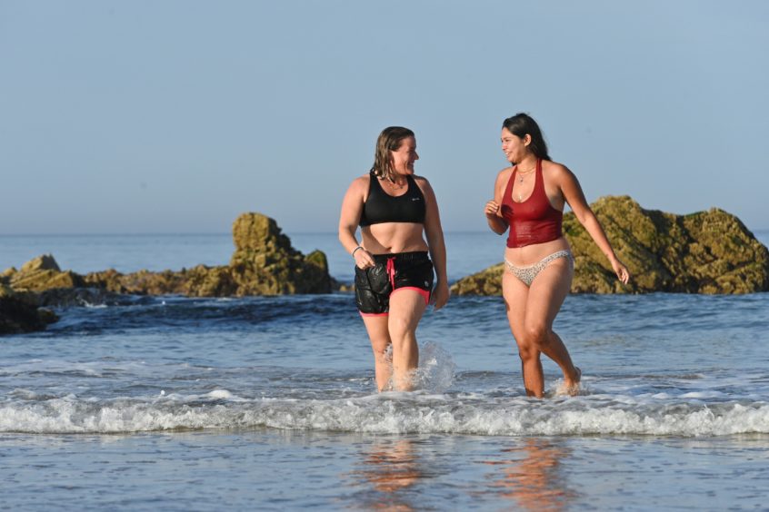 Zahra Abdul from Tarves (red) and Gemma Emslie from Aberdeen are pictured at Cullen beach, Moray on the hottest day of September in 100 years, Pictures by Jason Hedges.