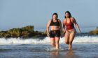 Zahra Abdul from Tarves (red) and Gemma Emslie from Aberdeen are pictured at Cullen beach, Moray on the hottest day of September in 100 years. Pictures by Jason Hedges.
