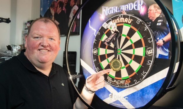 John Henderson at home in Huntly with his World Cup of Darts medal