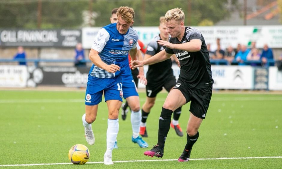 Peterhead defender Jason Brown (right) in action against Montrose.