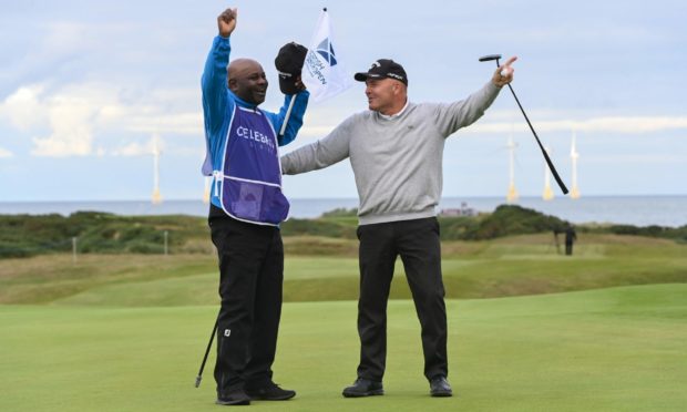 Thomas Levet leads the crowd in singing happy birthday to caddie Marcel Manieteka following his Scottish Senior Open win at Royal Aberdeen.