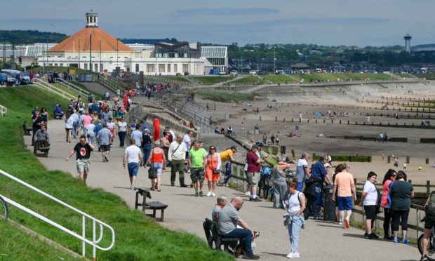 People enjoy warm weather on Aberdeen beach in June. Photo: Kenny Elrick/DCT Media