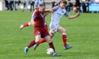 Keith's Michael Selfridge, left, battles with James Chalmers of Turriff